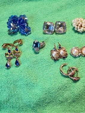 11 sets of gold tone earrings with colored stones. Great for any occasion.